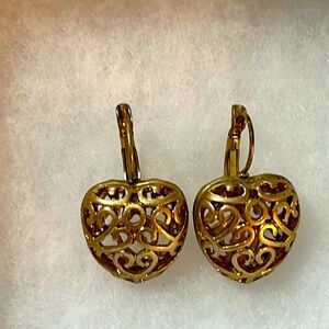 Gold tone heart shaped earrings with secure clasp.